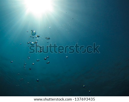 underwater sun reflections and air bubbles