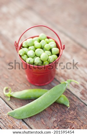 Green peas in a small bucket.
