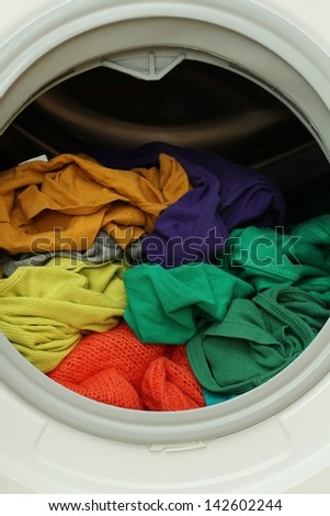 Washing machine full of dirty clothes
