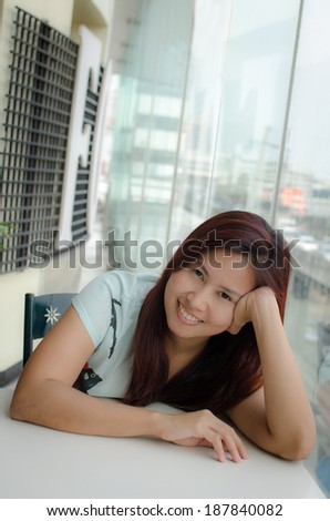Asian woman smiling looking at camera