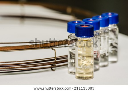 Analytical chemistry sample vial (blue screw cap) with column