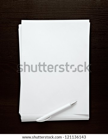 empty paper white pen on dark desk
