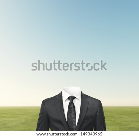 man without head and green field background