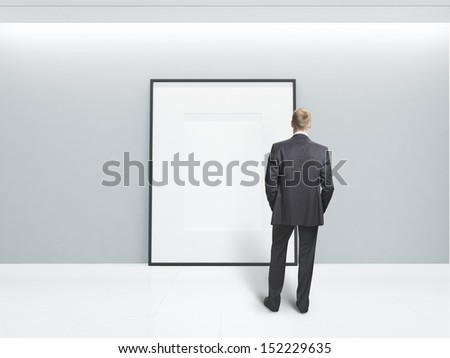 businessman looking at blank poster