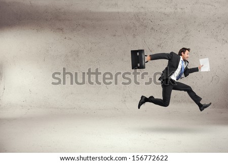 Businessman Running With Some Documents In His Hand