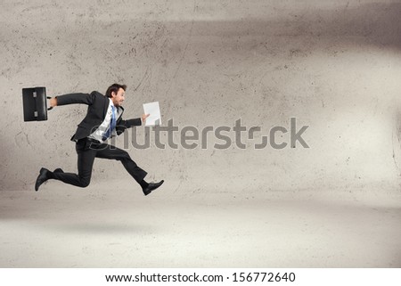 businessman running with some papers in his hand