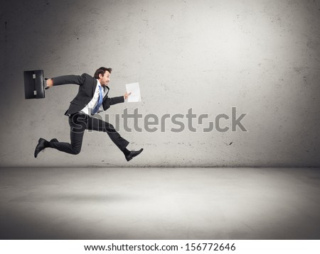 Businessman Running With Papers And Briefcase In His Hands