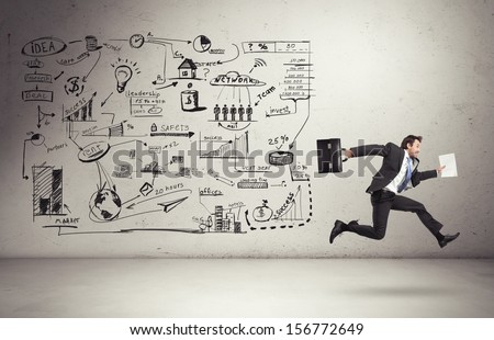business strategy on a wall and running businessman