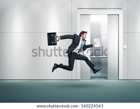 Running Businessman And Open Lift Door
