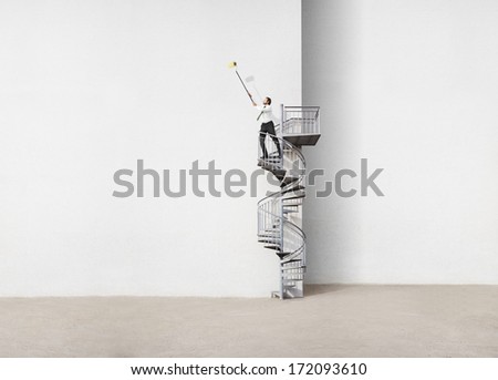 Businessman standing on spiral staircase and drawing
