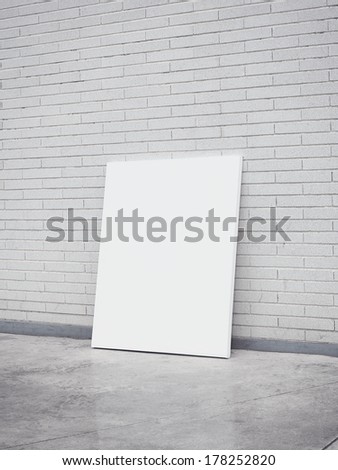 White brick wall and blank poster