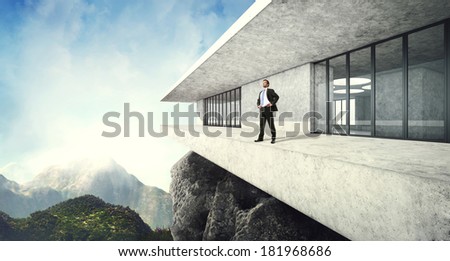 Successful man in his contemporary luxury house in mountains