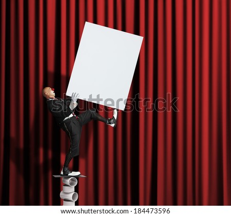 Clown balancing with blank poster in his hands