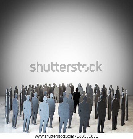 businessman standing among people silhouettes