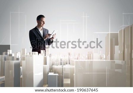 Businessman with tablet PC working with a modern city project