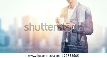 Double exposure of city and business man with cup of coffee