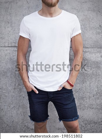 Young man wearing white t-shirt on bright concrete background