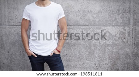 man wearing white t-shirt on bright concrete background