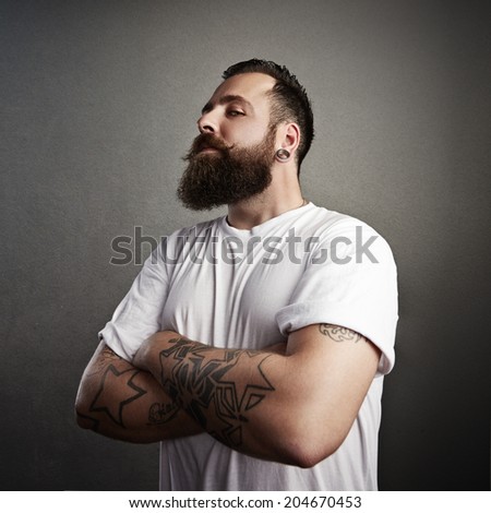 Tattooed brutal man wearing white t-shirt
