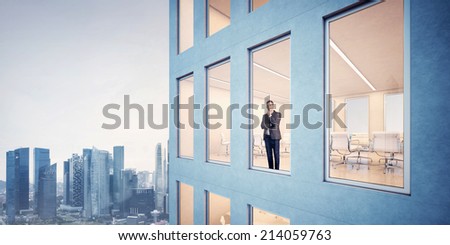 Businessman in office looking through window