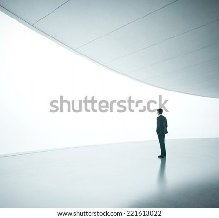 Business man in front of wide white screen