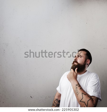 Portrait of a brutal bearded man thinking