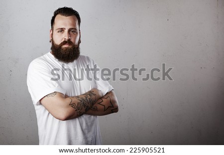 Tattooed man wearing white t-shirt