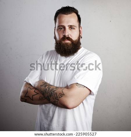 Portrait of a tattooed man wearing white t-shirt