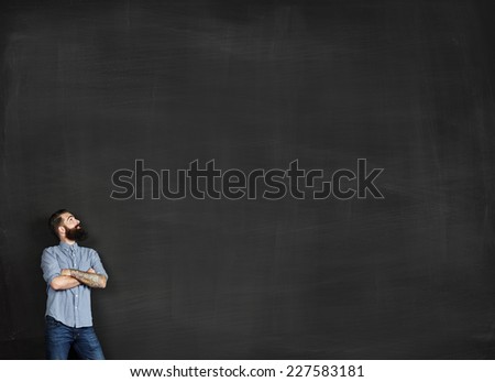 Portrait of tattooed man looking at chalkboard
