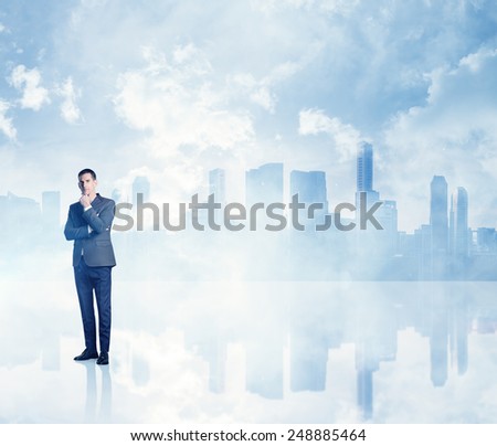Thoughtful businessman on megalopolis background