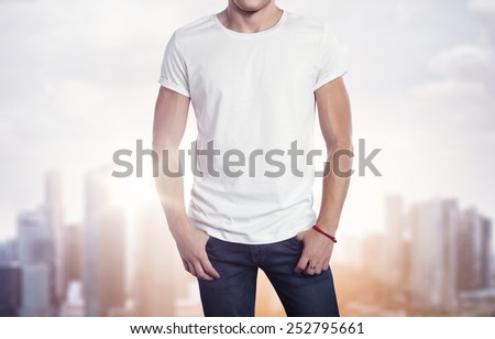 Man wearing white t-shirt on blurred city background