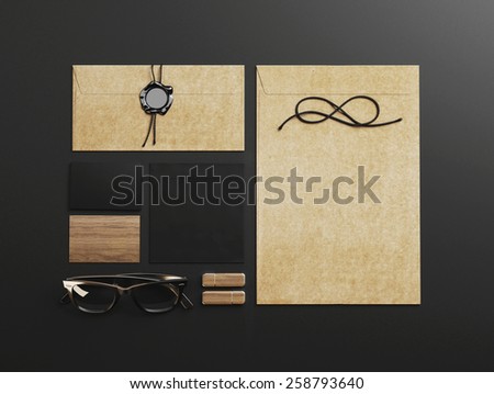 Set of black and craft identity elements on black paper background