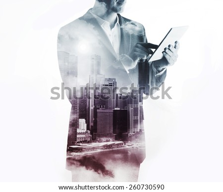 Double exposure with businessman using digital tablet