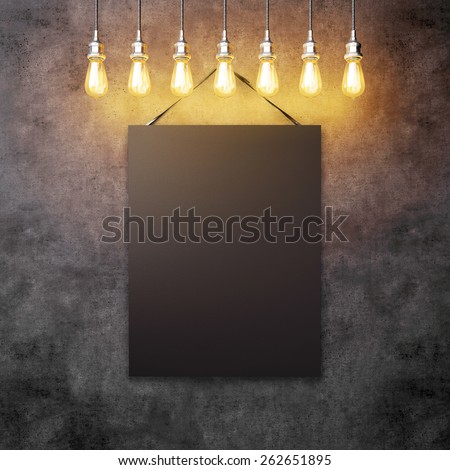 Black canvas hanging under decorative vintage light bulbs