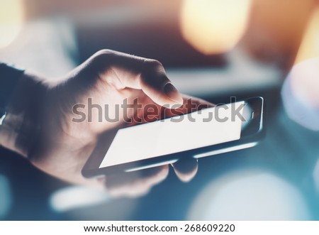 Closeup of man\'s hand using smartphone with effects