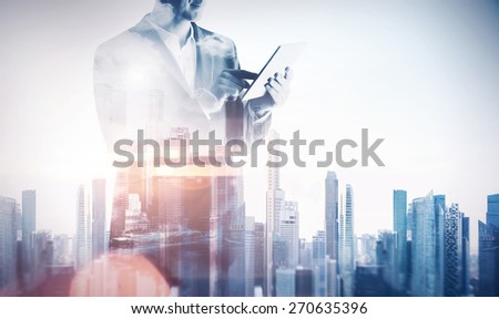 Double exposure with businessman using digital tablet. With special lighting effects