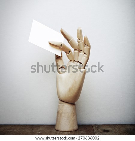 Wood hand holding blank business card