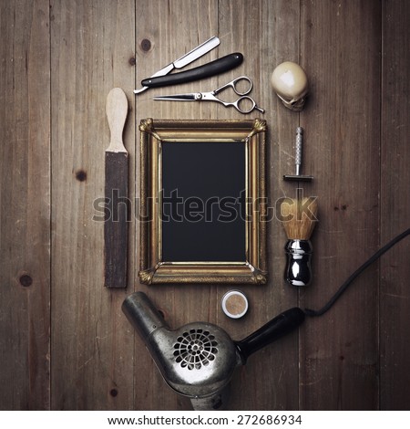 Vintage barber tools and black poster with a frame