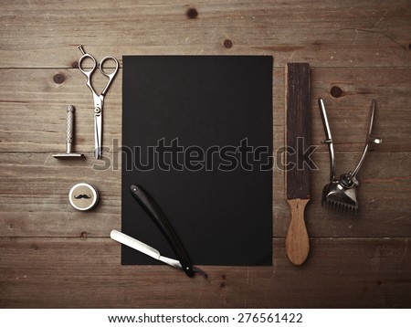 Barber shop tools and black picture frame on wood desk