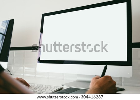Man hands with generic design computer on the table.