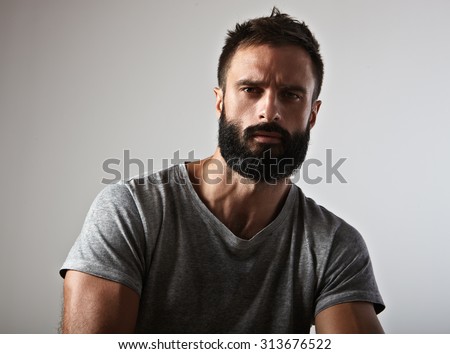 Portrait of a handsome bearded man looking at camera