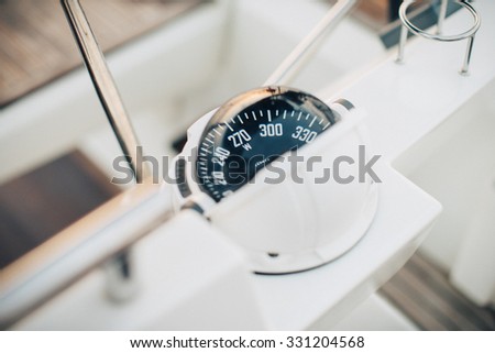 Big compass on a boat showing direction. horizontal