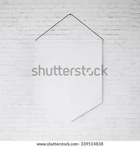 White pennant hanging on the white bricks wall at background. 3d render