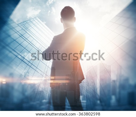 Portrait of bearded gentleman in suit. Double exposure skyscraper on the background. Visual effects.