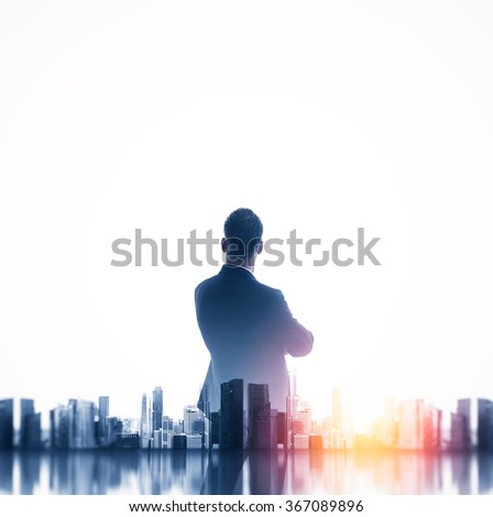 Buesinessman wearing classic suit and looking cityscape. Double exposure.