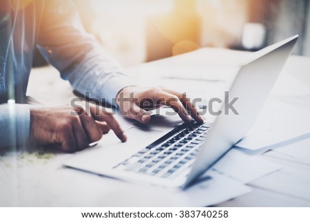 Photo businessman working with generic design notebook. Typing message, hands keyboard. Blurred background, bokeh effect