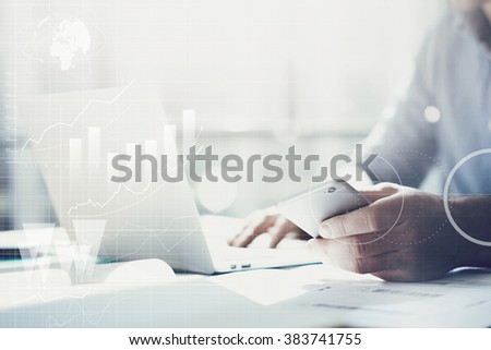 Businessman working with generic design notebook. Holding smartphone in hands. Worldwide connection technology interface