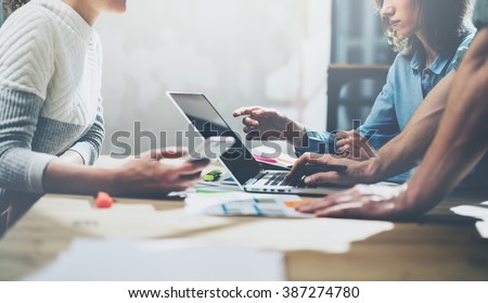 Team succes concept. Businessmans crew working with new startup project. Generic design notebook on wood table.  Analyze plans hands, keyboard. Blurred background, film effect