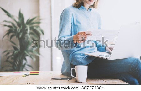 Student work process concept. Photo young woman working university project with generic design laptop. Analysis plans hands. Blurred background, film effect. Horizontal