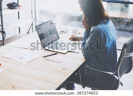 Student work process concept. Young woman working university project with generic design laptop. Analysis plans hands, talking smartphone. Blurred background, film effect. Horizontal